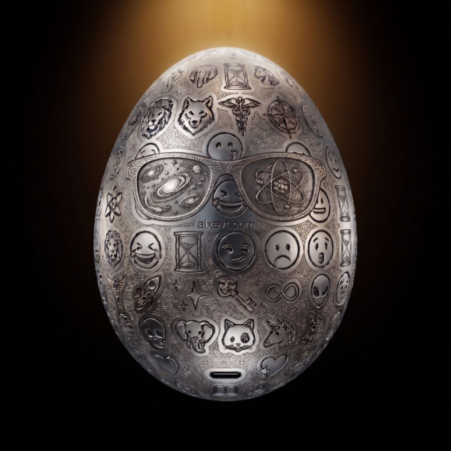 A white-metal engraved egg lit from above against black.