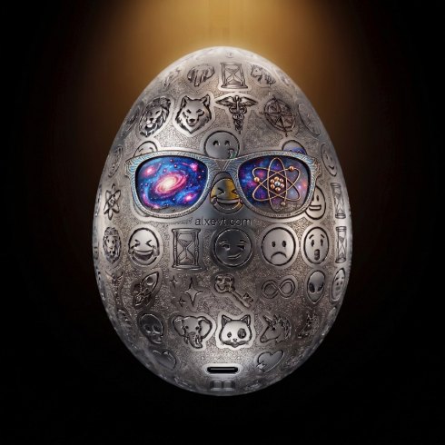 An engraved palladium egg covered in emoji-like reliefs, wearing glasses showing a galaxy and an atom.